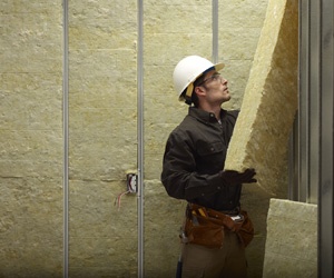 Man installing mineral wool insulation