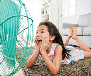 girl in front of a green fan