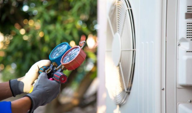 Technician servicing HVAC unit.