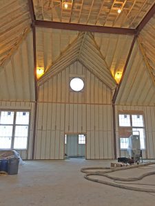 Spray foam insulation installed in the walls and high ceiling of a sport court.