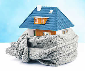 Insulation concept of small model of home wrapped in scarf