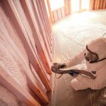 man installing spray foam insulation