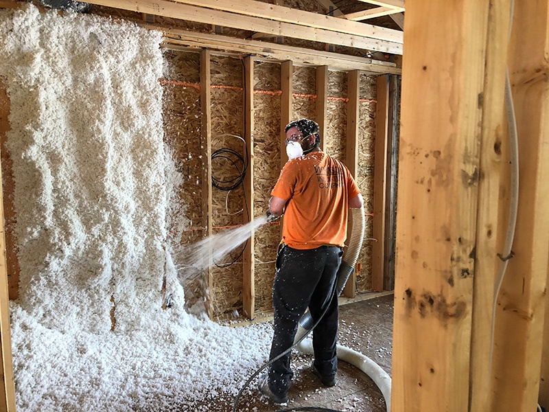 Man installing JM Spider insulation