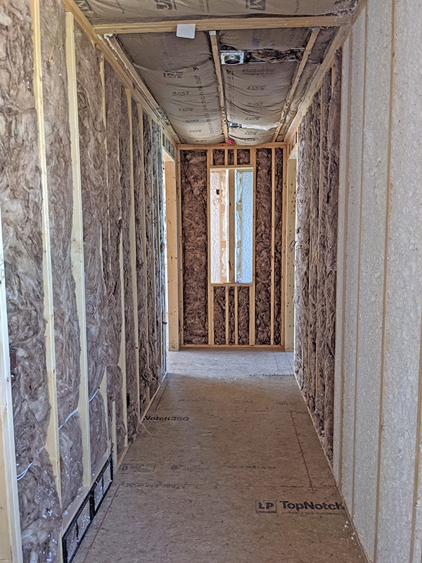 Fiberglass insulation and JM spider insulation in hallway