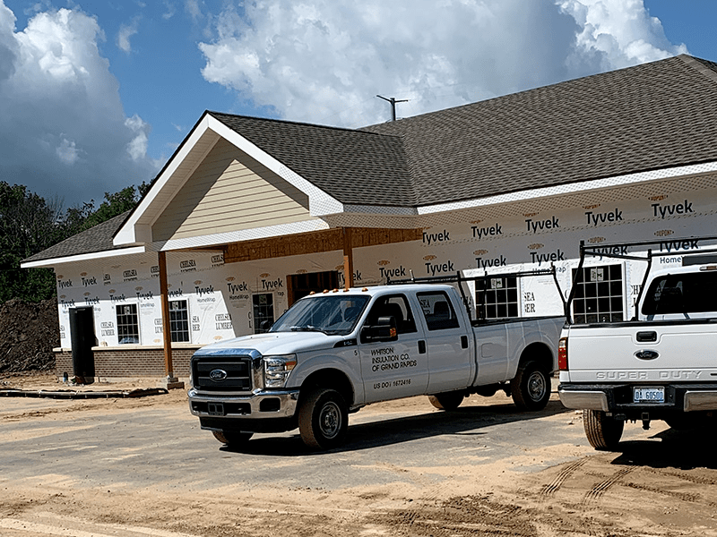 Whitson Insulation truck parked in front of commercial insulation project