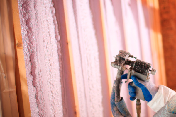 Closeup of spray foam insulation installation.