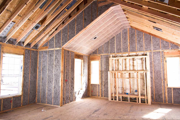 Cellulose insulation dense packed in wall cavity of large new construction space.