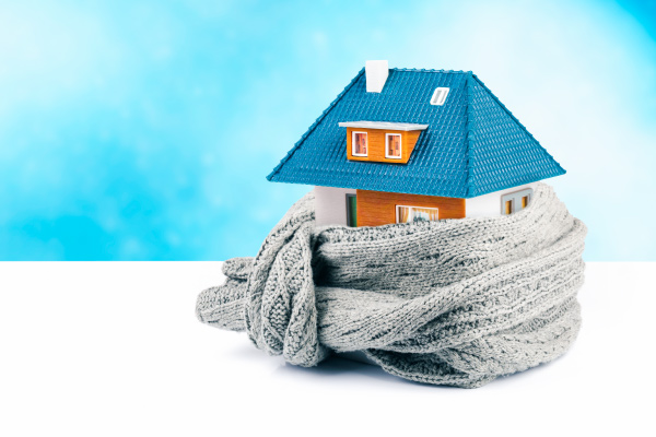 Miniature house wrapped with a scarf