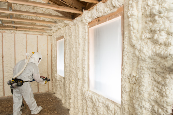 Man installing spray foam insulation.