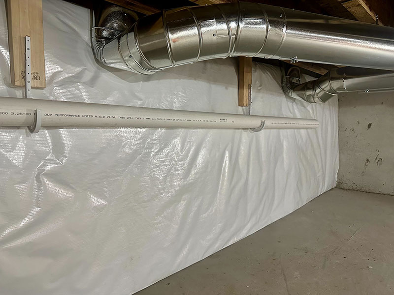 Creating a sealed and insulated crawlspace in Northport, MI, Whitson Insulation used vinyl-faced fiberglass blankets to provide a thermal and vapor barrier.