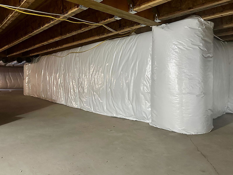 In this Northport, MI crawlspace project, Whitson Insulation improved home comfort with R-19 fiberglass insulation wrapped in a durable vinyl vapor barrier.