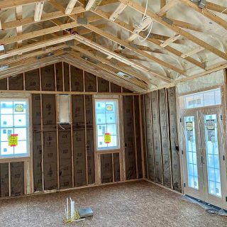 Remodeled room with spray foam ceiling and kraft-faced fiberglass insulation installed in walls