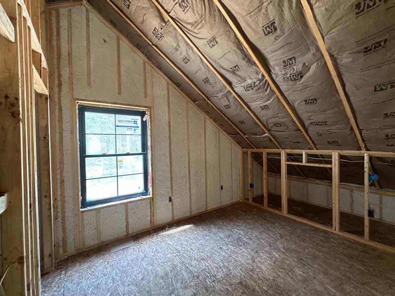 Completed bonus-room attic with foamed walls and fiberglass-batt ceiling in new Baldwin, MI home.