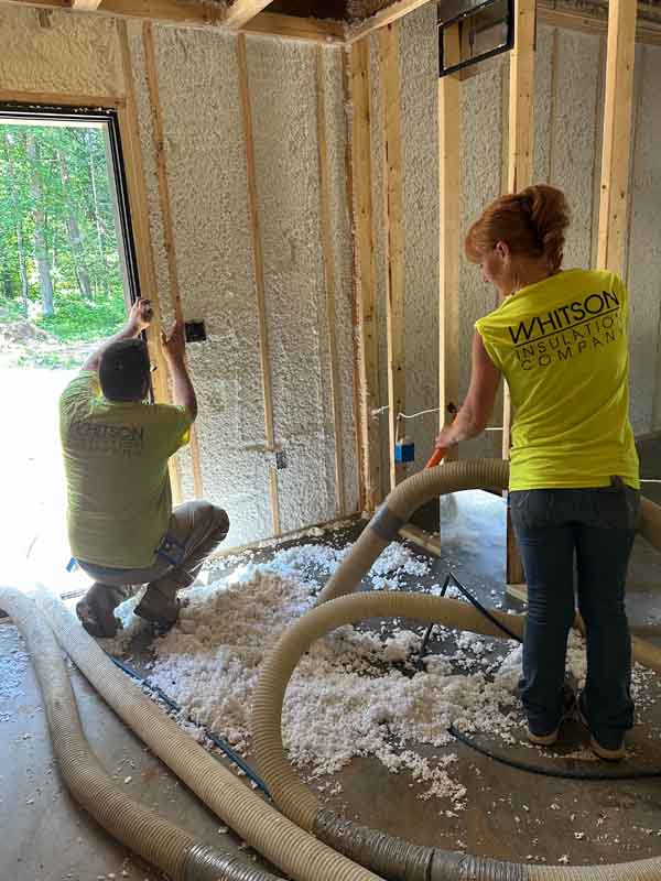 Whitson Insulation technicians blowing Spider fiberglass into exterior walls of the Wolf Lake build, Baldwin MI.