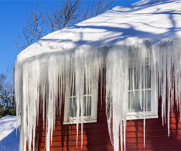 Ice dam on roof causing water infiltration and attic damage.