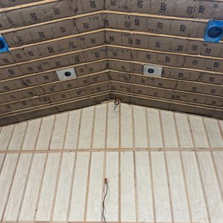 View of newly framed church addition showing spray-foamed walls (R21) and a vaulted ceiling insulated with fiberglass batts (R38) in Walker, MI.