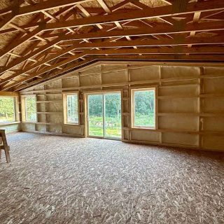 Fully insulated framed wall with smooth closed-cell foam coverage in barndominium