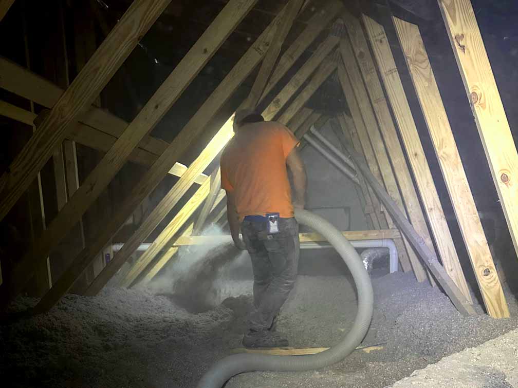 A Whitson installer blowing in cellulose to boost attic R-value. A Whitson installer blowing in cellulose to boost attic R-value.